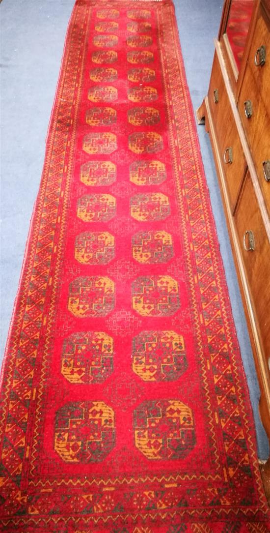 A Bokhara madder ground runner 385 x 52cm